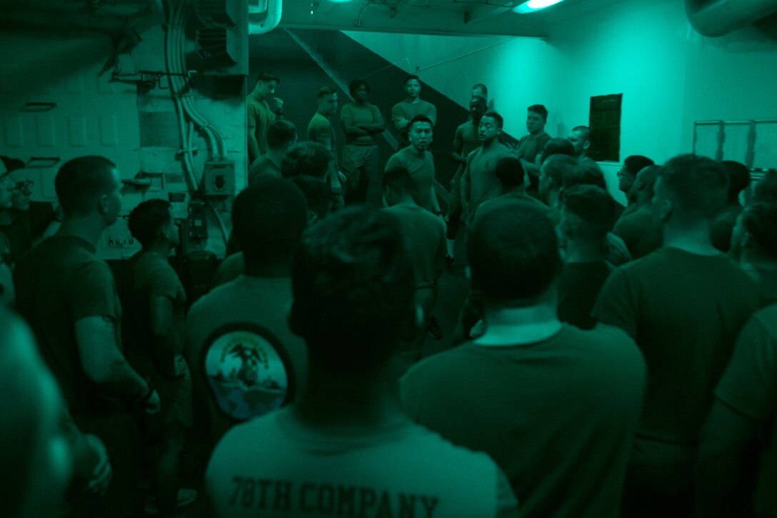 U.S. Marine Corps Sgt. On Y. Lau, center, an air traffic controller with Marine Medium Tiltrotor Squadron (VMM) 162 (Reinforced), 26th Marine Expeditionary Unit, speaks to Marines participating in corporal’s course aboard the amphibious assault ship USS Iwo Jima (LHD 7), Feb. 15, 2018. The Marines participated in corporal’s course as part of a period of military education to further develop the skills and knowledge of noncommissioned officers. (U.S. Marine Corps photo by Cpl. Jered T. Stone)