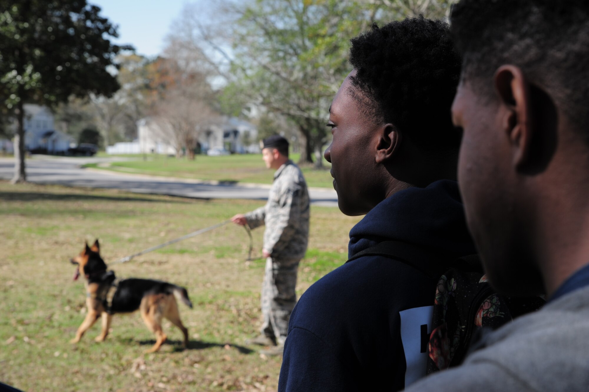 Students from the Charleston area watch as members from the 628th Security Forces Squadron demonstrate K9 operations during Tuskegee Airmen Career Day, Feb. 27, 2018 at Joint Base Charleston, S.C. (U.S. Air Force photo by SrA Jonathan Lane).