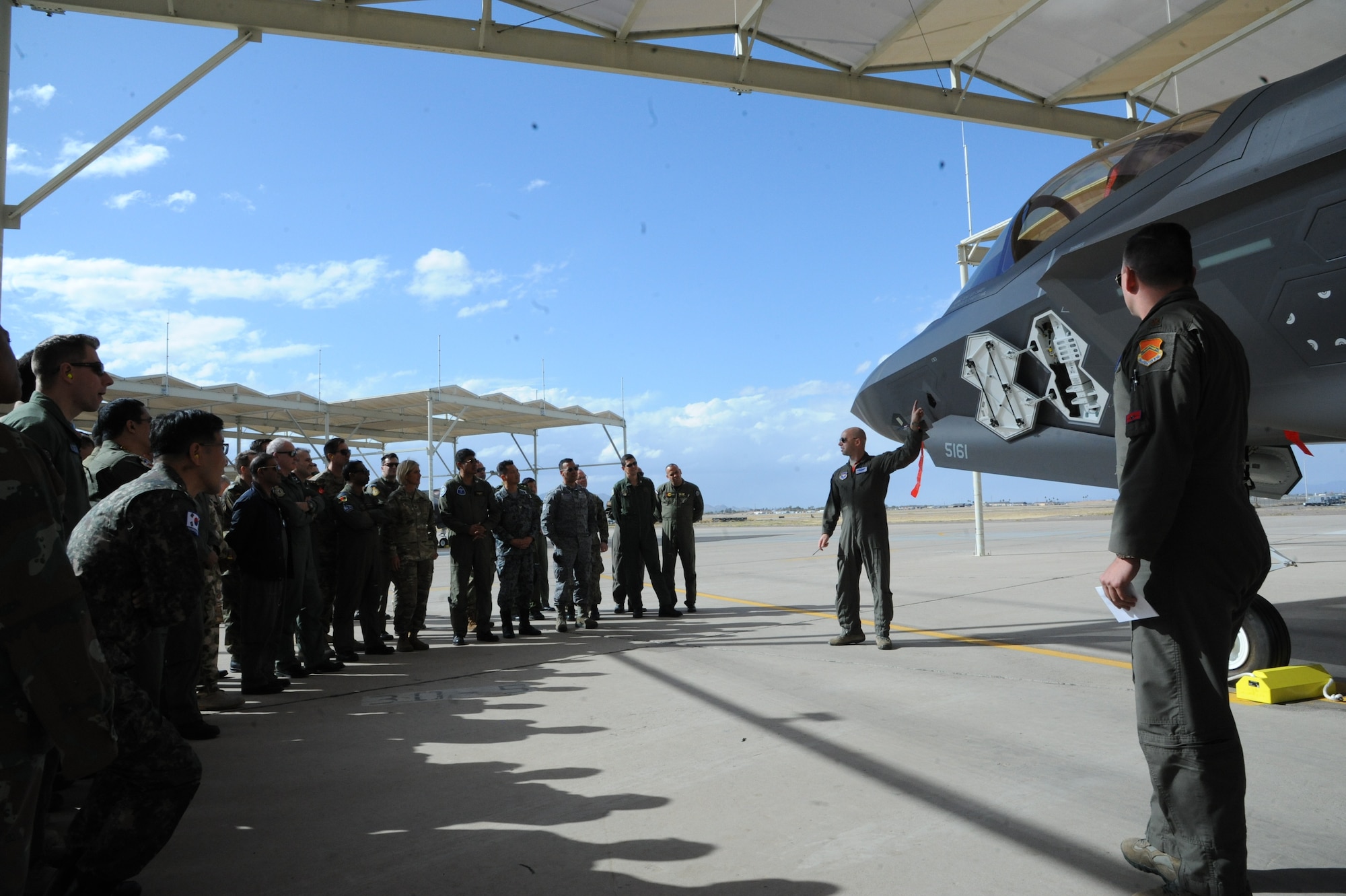 United States Air Force Air War College International Fellows students receive a briefing on the F-35 Lightning II at the 63rd Fighter Squadron at Luke Air Force Base, Ariz., Feb. 28, 2018. The AWC curriculum is designed to expose students to U.S. military operations, training, organization, equipment and facilities. (U.S. Air Force photo/Tech. Sgt. Luther Mitchell Jr.)