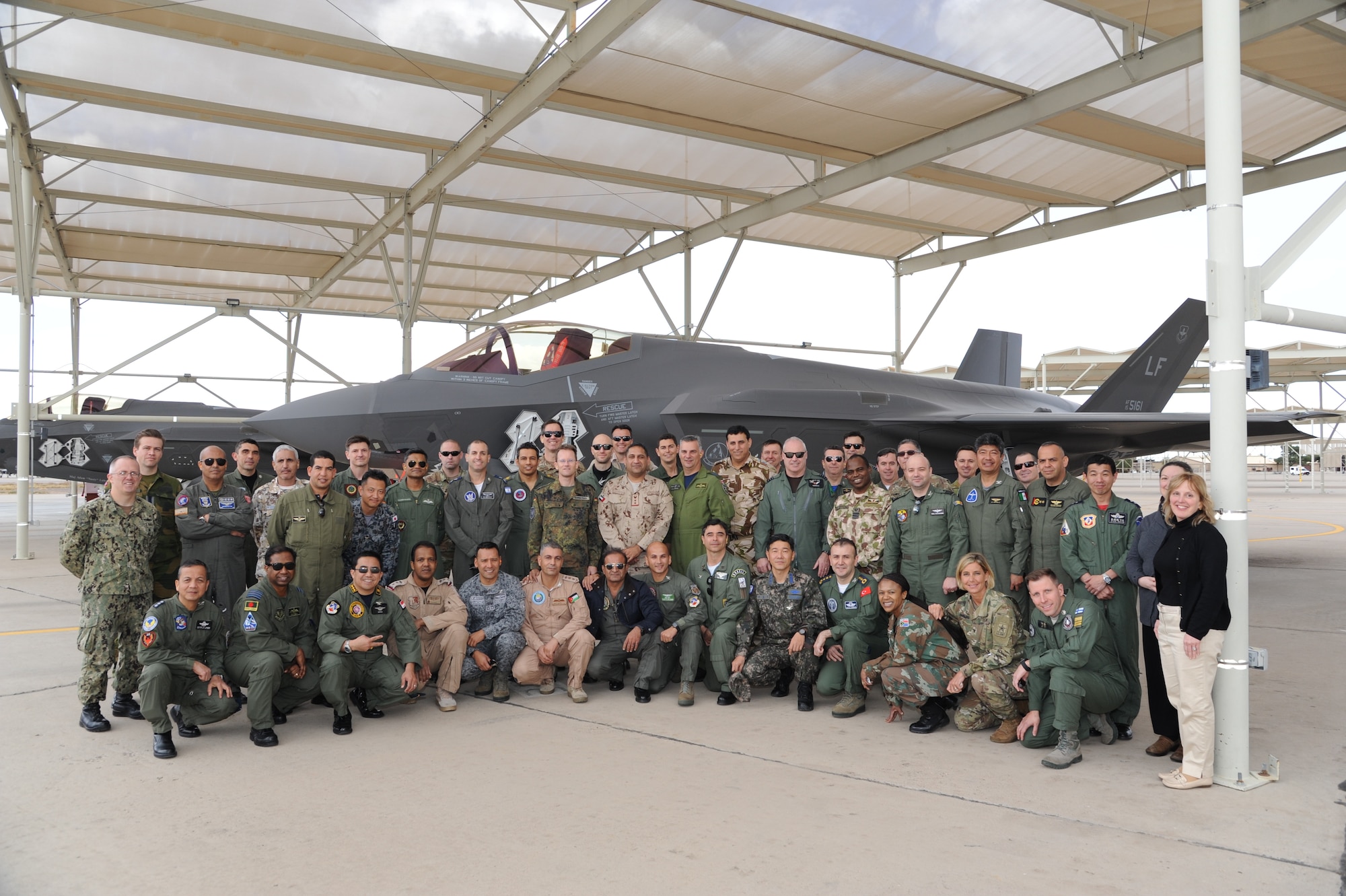 United States Air Force Air War College International Fellows students pose for a group photo in front of an F-35 Lightning II at the 63rd Fighter Squadron at Luke Air Force Base, Ariz., Feb. 28, 2018. The AWC international students received a personal look at how Luke is building the future of Airpower. (U.S. Air Force photo/Tech. Sgt. Luther Mitchell Jr.)