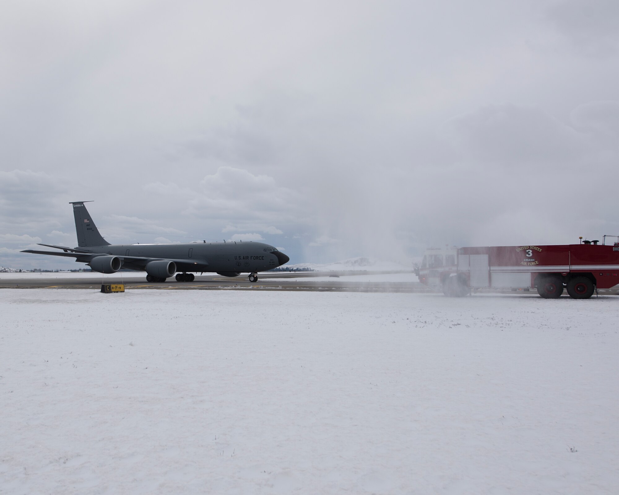 Col. Matthew Yakely, the commander of the 141st Operations Group, taxis through spray from fire engines from the 92d Civil Engineer Squadron after completing his final flight on a KC-135 February 23, 2018 at Fairchild Air Force Base, Wash. Col. Yakely has accumulated than 5,590 flying hours across six different airframes, with his most recent being the KC-135 Stratotanker.