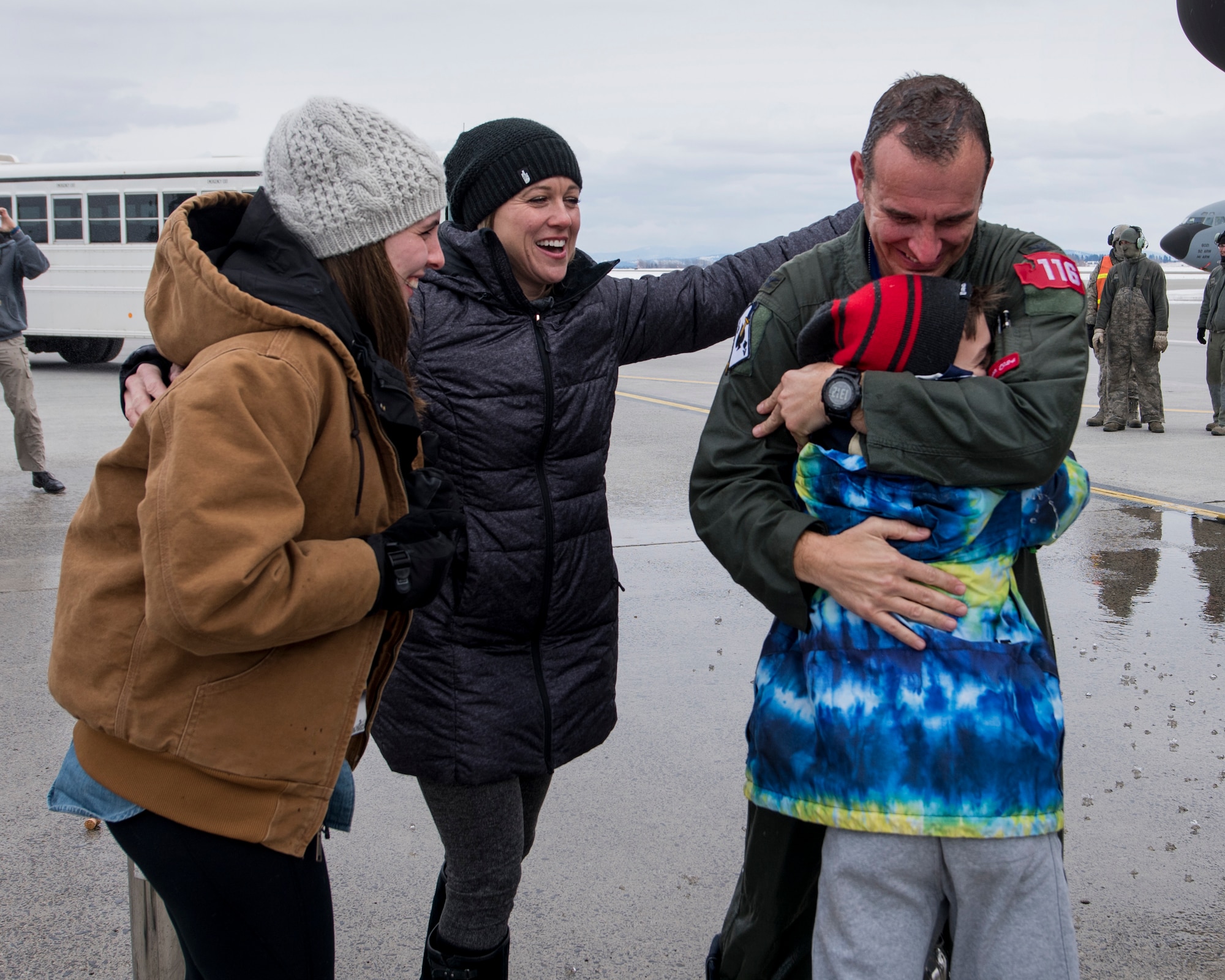 Col. Matthew Yakely, commander of the 141st Operations Group, embraces members of his family after completing his final flight on a KC-135 February 23, 2018 at Fairchild Air Force Base, Wash. Col. Yakely is retiring after serving more than 24 years in the Air Force, with nearly 16 of those years with the 141st Air Refueling Wing.