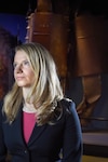 Miranda Summers Lowe, the curator of modern military history at the Smithsonian Institution, sits in front of a section of the World Trade Center on display in the Smithsonian’s National Museum of American History.