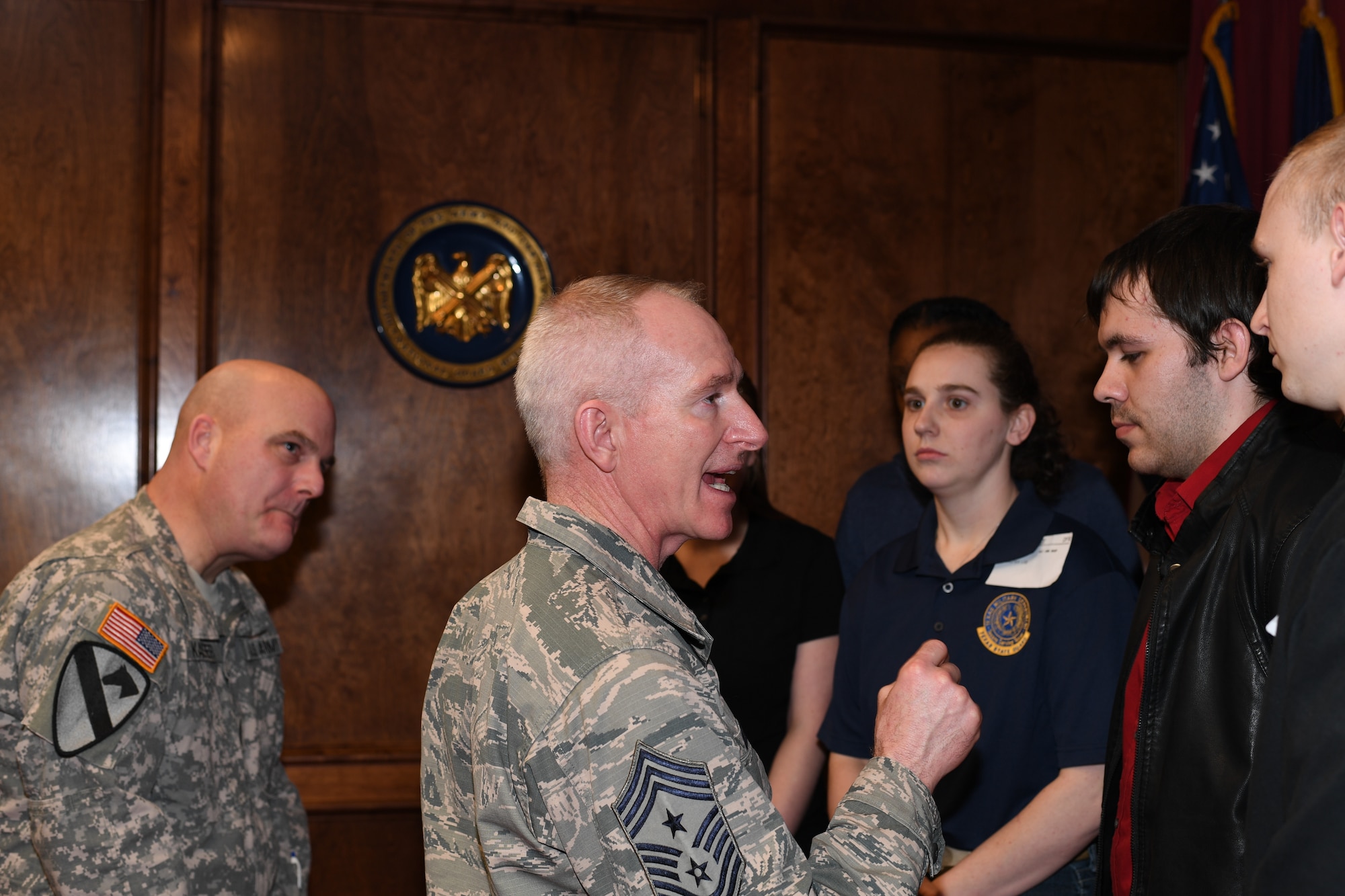 Chief Master Sgt. Alan Boling, 8th Air Force command chief, gives advice as the newly sworn-in recruits prepare to ship out to basic training.