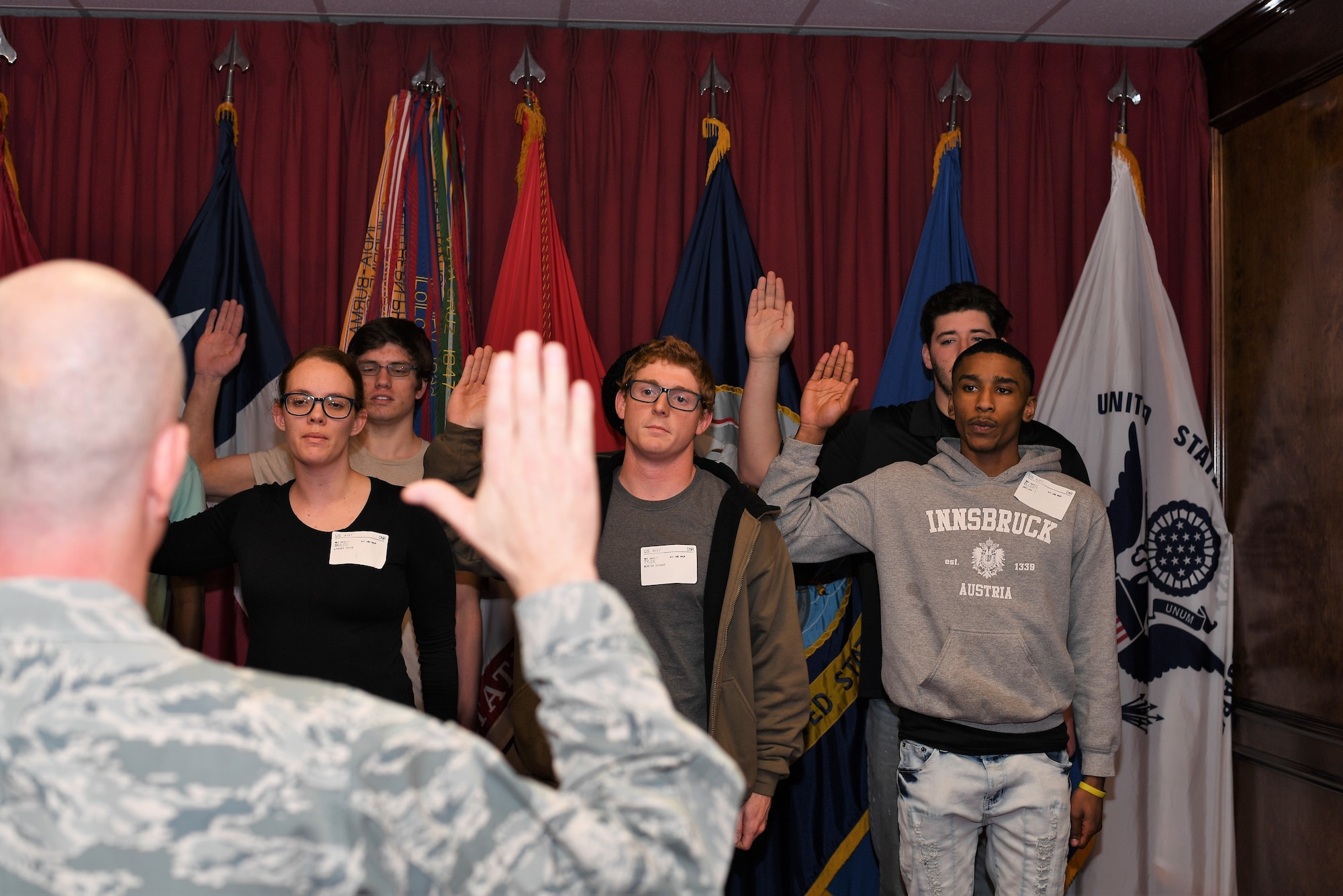 Brig. Gen. Jonathan Ellis from 8th Air Force swears in Navy and Army recruits at the Shreveport MEPS