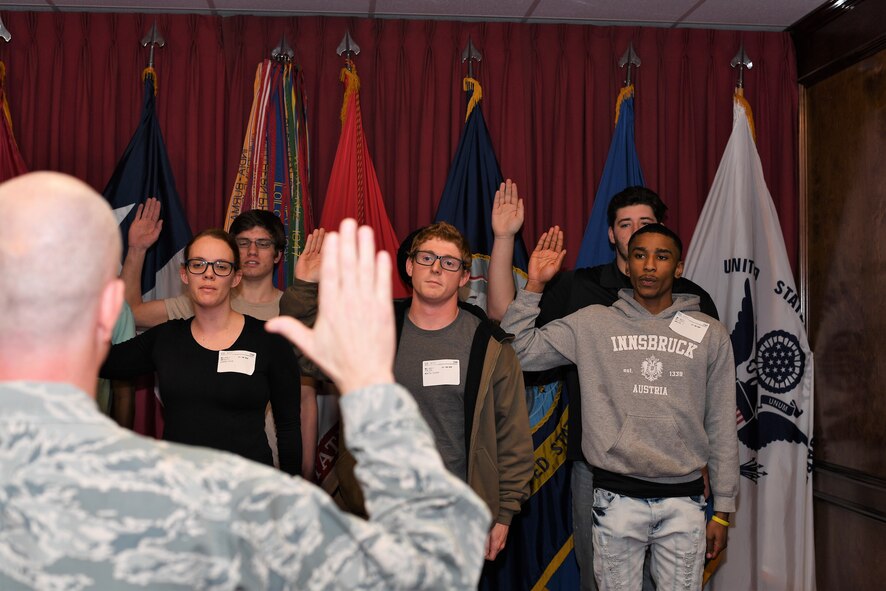 Brig. Gen. Jonathan Ellis from 8th Air Force swears in Navy and Army recruits at the Shreveport MEPS