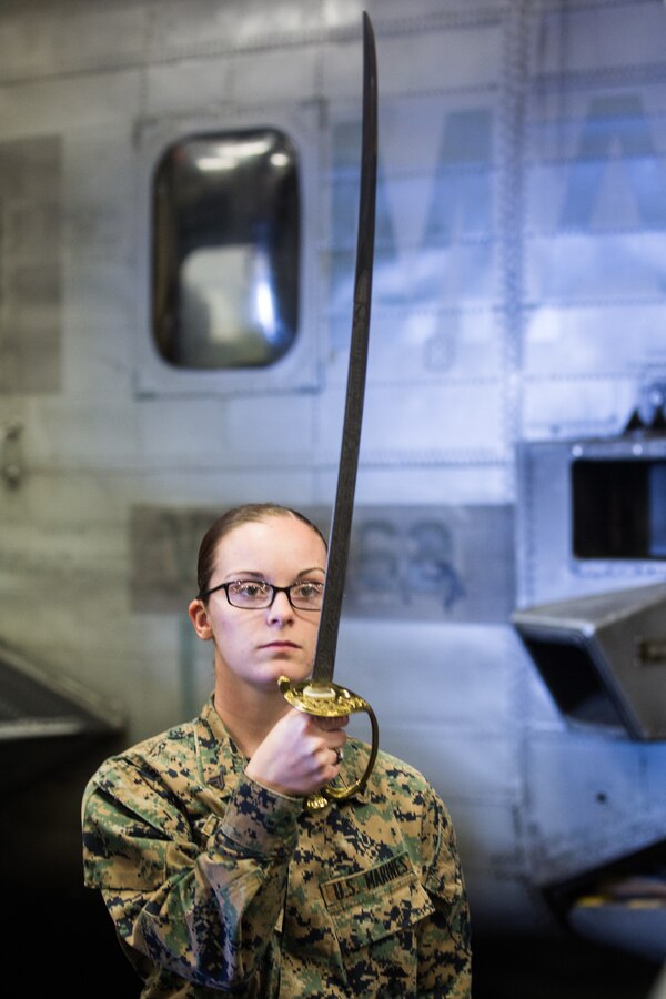 ATLANTIC OCEAN (February 21, 2018) U.S. Marine Corps Cpl. Rebecca R. Vanderpool, an ammunition technician with Combat Logistics Battalion (CLB) 26, 26th Marine Expeditionary Unit, presents a noncommissioned officers sword during sword manual practice as part of Corporals Course aboard the amphibious assault ship USS Iwo Jima (LHD 7), Feb. 21, 2018. The Marines participated in Corporals Course as part of a period of military education to further develop the skills and knowledge of noncommissioned officers while underway. (U.S. Marine Corps photo by Cpl. Jered T. Stone/Released)