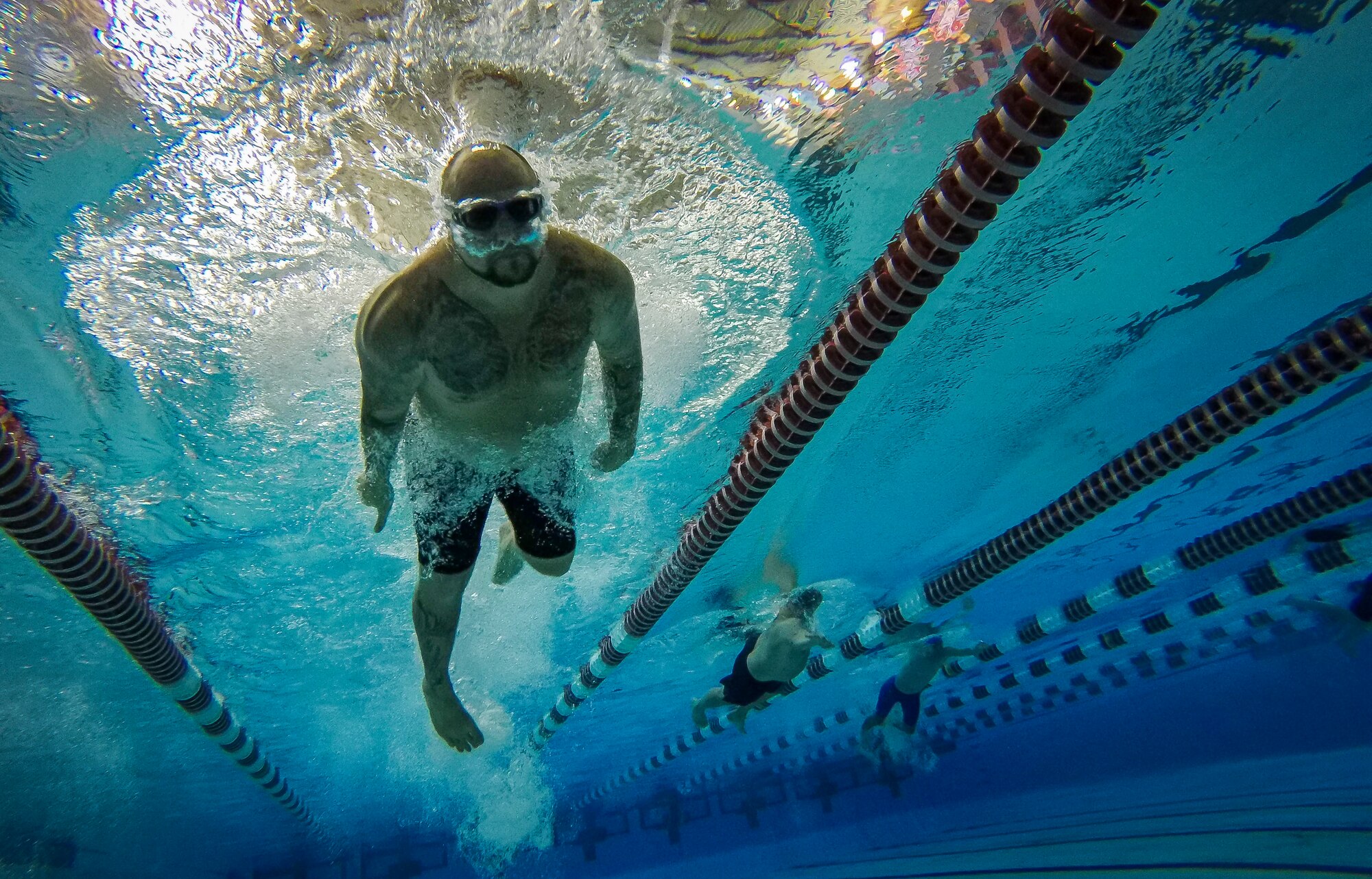 Service members and veterans compete in the 100-meter freestyle swimming event in the 5th Annual Air Force Wounded Warrior Trials at the University of Nevada Las Vegas pool Feb. 25, 2018. Service members are participating in adaptive athletic reconditioning for lasting effects on physical and emotional recovery. (U.S. Air Force photo by Senior Airman Kevin Tanenbaum)