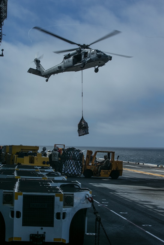 ATLANTIC OCEAN (February 25, 2018) A U.S. Navy MH-60S Seahawk with Helicopter Sea Combat Squadron (HSC) 28, prepares to offload cargo during a replenishment at sea in the Atlantic Ocean, Feb. 25, 2018.
