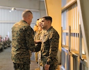 SSgt Joseph T. Dickenson the first Marine to receive a coin from Brigadier General Jason Q. Bohm Commanding General, Training Command at Fort Leonard Wood, MO Jan. 24th, 2018. SSgt Dickenson is in charge of the Leadership Professional Development Training program which was only put in effect less than a year and has been successful with his leadership, the command takes time to recognize him for his outstanding effort.  (U.S. Marine Corps photo by Sgt. Teng Yang)