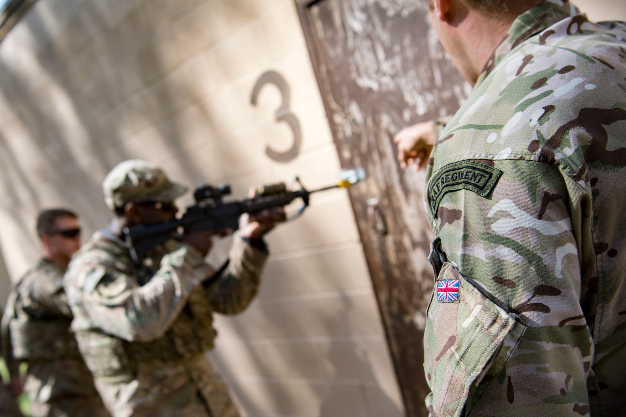 British Royal Air Force Sgt. Glenn Risebrow, right, 15th Squadron senior noncommissioned officer in charge of training, provides training points to Airmen from the 824th Base Defense Squadron during close-quarters battle training, Feb. 28, 2018, at Moody Air Force Base, Ga. The 820th Base Defense Group welcomed a member of the British Royal Air Force to embed into multiple training situations to help strengthen combined operations between U.S. and British forces. (U.S. Air Force photo by Senior Airman Daniel Snider)