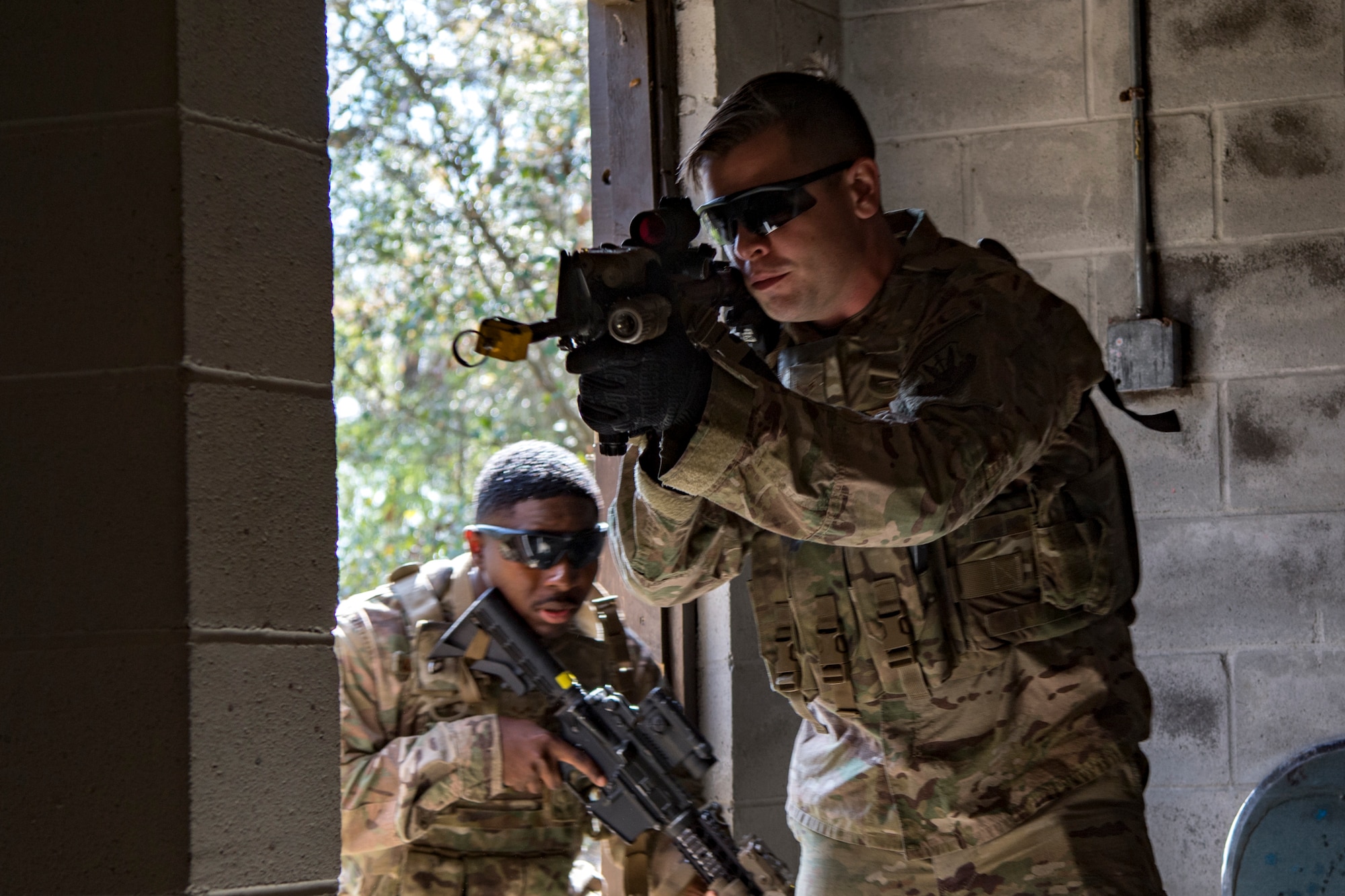 Airmen from the 824th Base Defense Squadron storm a building during close-quarters battle training, Feb. 28, 2018, at Moody Air Force Base, Ga. The 820th Base Defense Group welcomed a member of the British Royal Air Force to embed into multiple training situations to help strengthen combined operations between U.S. and British forces. (U.S. Air Force photo by Senior Airman Daniel Snider)