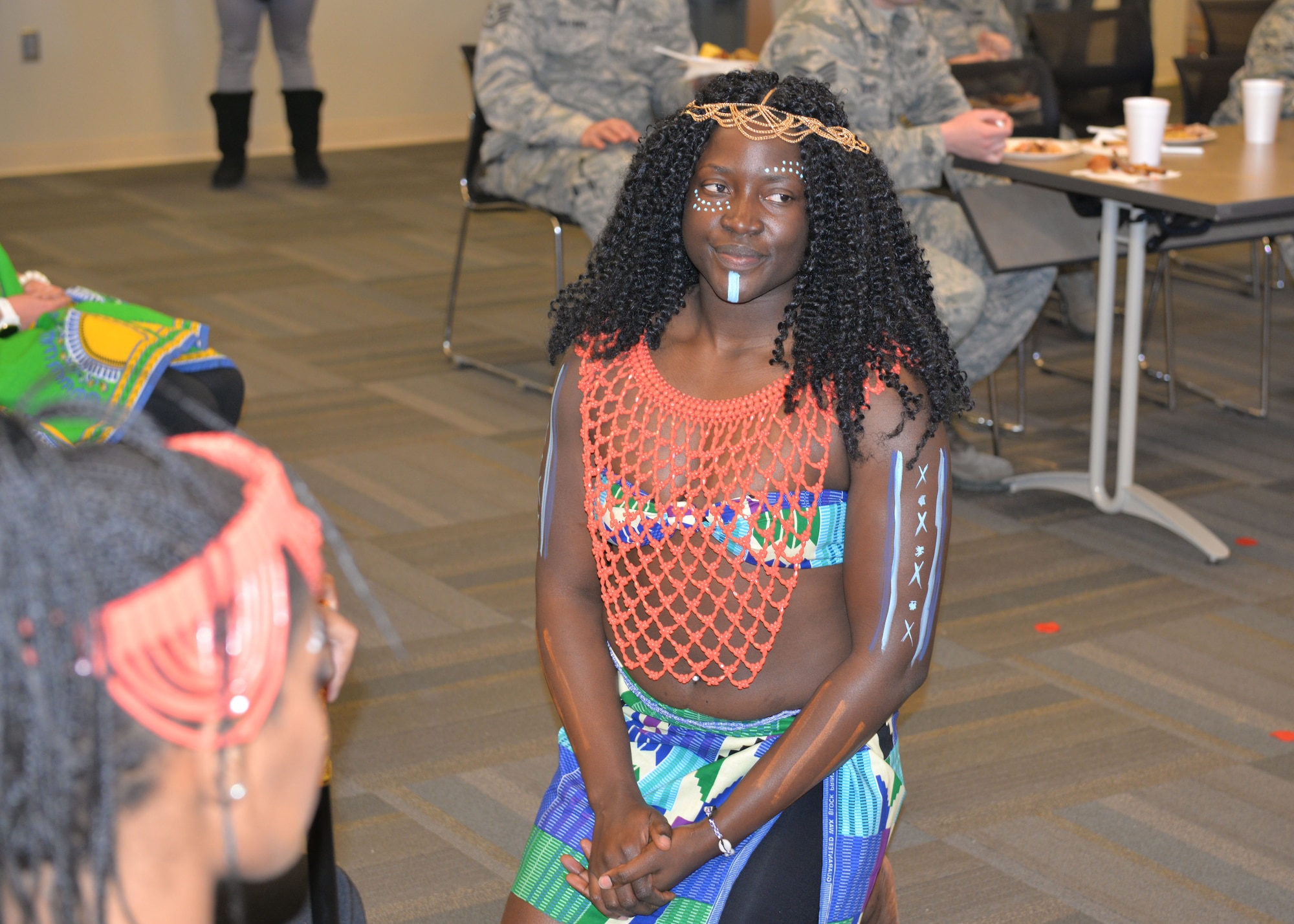 Airman 1st Class Georgette Ndamukong, a 28th Medical Group public health technician, plays the role of the princess during scene one of an African American History Month fashion show at Ellsworth Air Force Base, S.D., Feb. 23, 2018. Everyone greets the king and queen differently during a traditional West African wedding ceremony, and the fashion show educated participants of these African customs. (U.S. Air Force photo by Senior Airman Michella T. Stowers)