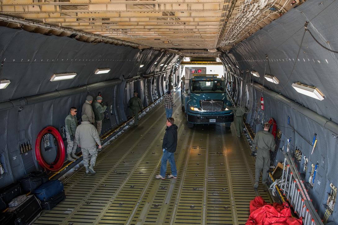 Members from multiple mission partners gathered to help load the aircraft for the Space and Missile Systems Center detachment at Kirtland. The equipment was being moved to Diego Garcia for a satellite operations mission.
