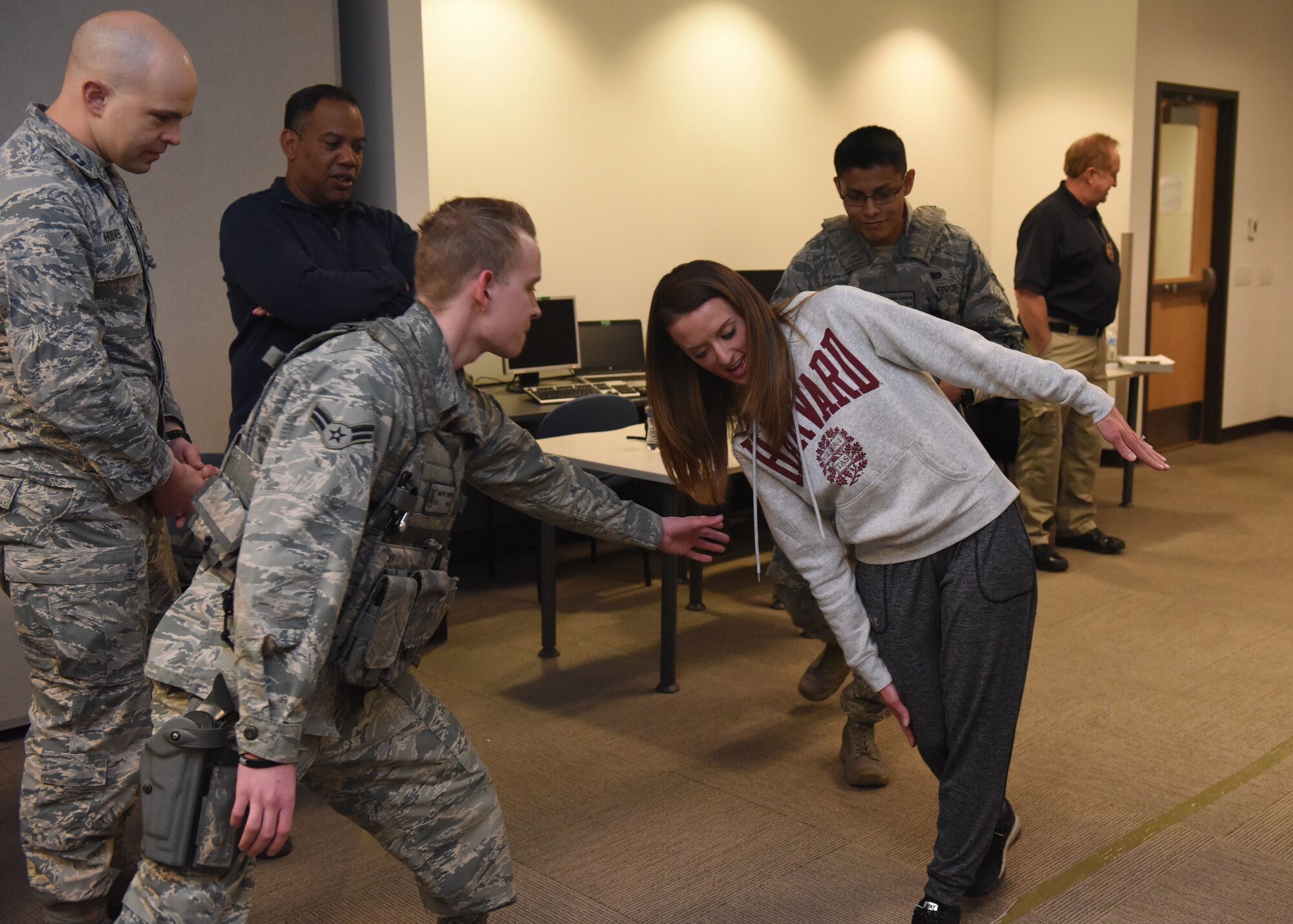 Tech. Sgt. Cassidy Wong, National Reconnaissance Office/Detachment 3 NCOIC Executive Support, falters in the midst of a field sobriety test as two security forces Airmen swoop in to catch her during Standardized Field Sobriety Training, Feb. 12, 2018, on Buckley Air Force Base. The 460th Security Forces Squadron participated in 3-day training presented by the Aurora Police Department Traffic Unit where they learned to administer sobriety tests as well as what it’s like to be tested in an inebriated state.(U.S Air Force photo by Senior Airman AJ Duprey)