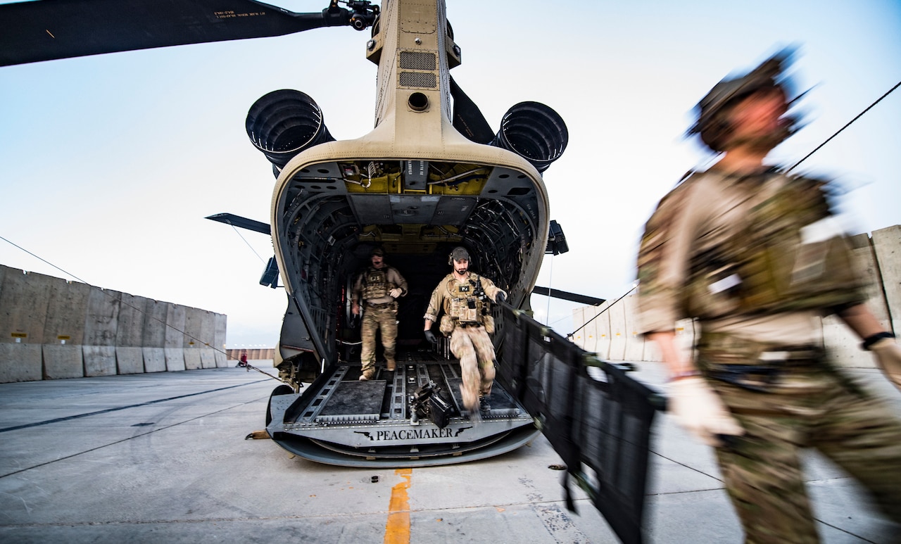 Air Force pararescuemen, assigned to the 83rd Expeditionary Rescue Squadron, 455th Air Expeditionary Wing, exit an Army CH-47 Chinook at Bagram Airfield, Afghanistan, Feb. 22, 2018. The pararescuemen primarily fly their missions on Army CH-47F Chinooks, making the 83rd ERQS the first joint personnel recovery team in Air Forces Central Command. (U.S. Air Force Photo by Tech. Sgt. Gregory Brook)