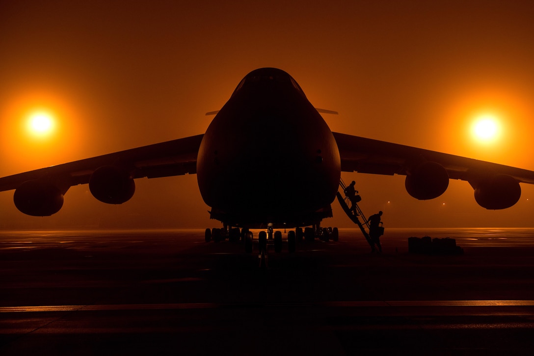 Airmen offload from a C-5M Super Galaxy aircraft.