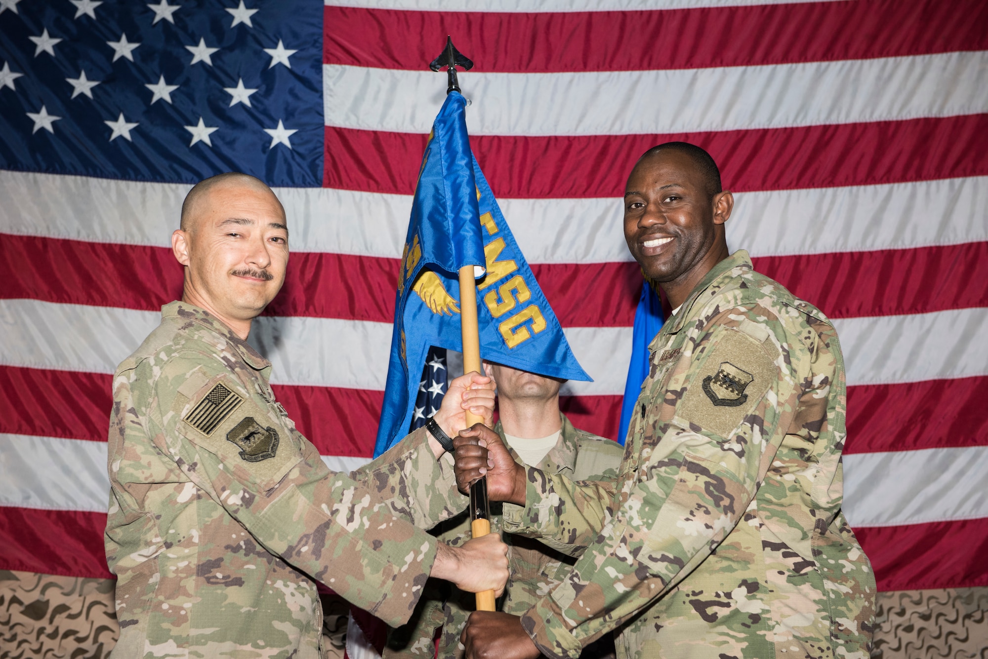 Col. Christopher Fuller, 332d Expeditionary Mission Support Group commander, transfers the command guidon to Lt. Col. Jamaal Mays during an assumption of command ceremony Feb. 28, 2018, at an undisclosed location. Mays assumes command of the 332d Expeditionary Logistics Readiness Squadron. (U.S. Air Force photo by Staff Sgt. Joshua Kleinholz)