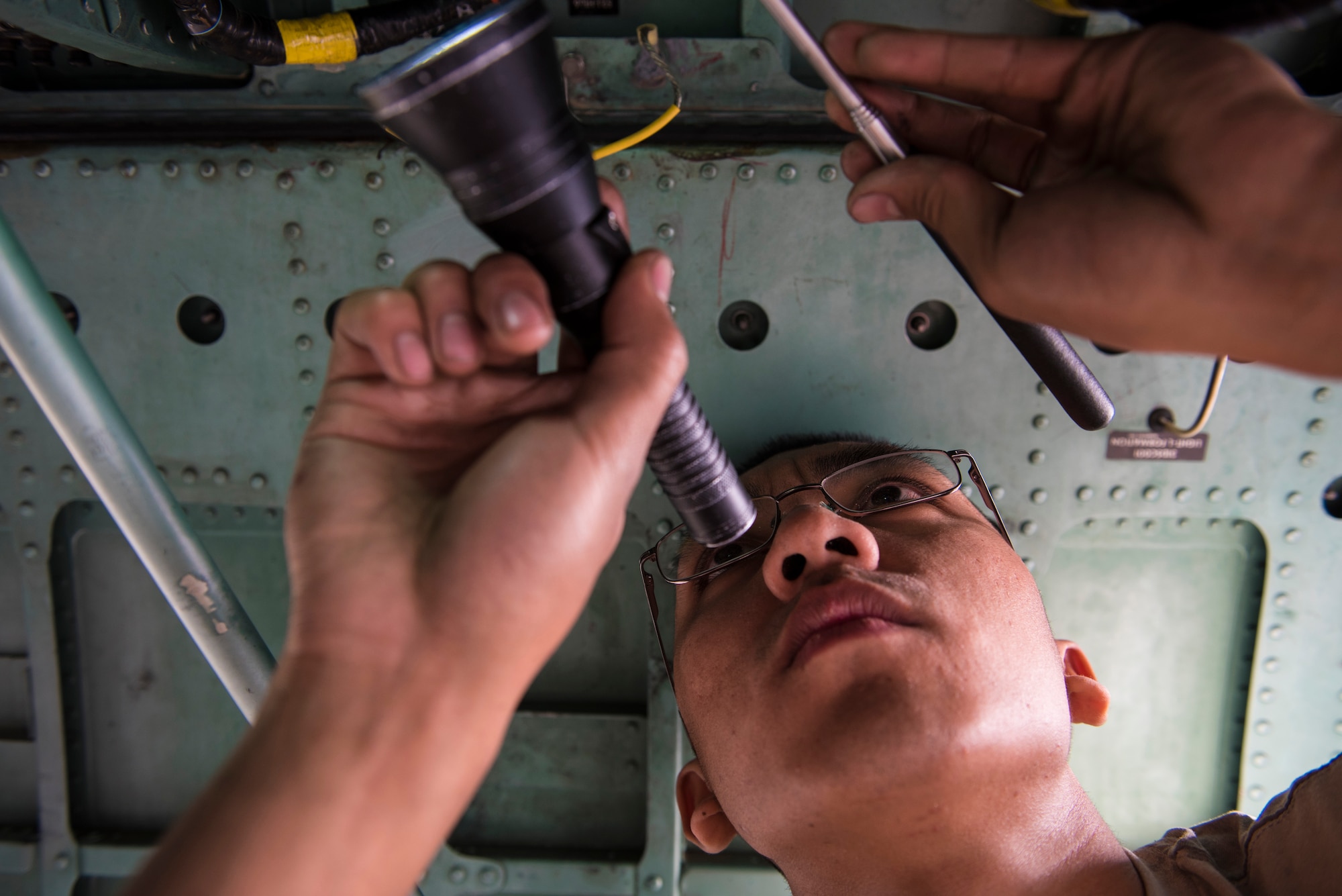 Senior Airman Rey Tenoso, a maintainer assigned to the 332d Expeditionary Maintenance Squadron, inspects components on an F-15E Strike Eagle during phase maintenance March 1, 2018, at an undisclosed location. During phase maintenance, every panel on the aircraft is removed and underlying components are inspected or replaced to ensure the aircraft can be safely operated to its potential going forward. (U.S. Air Force photo by Staff Sgt. Joshua Kleinholz)