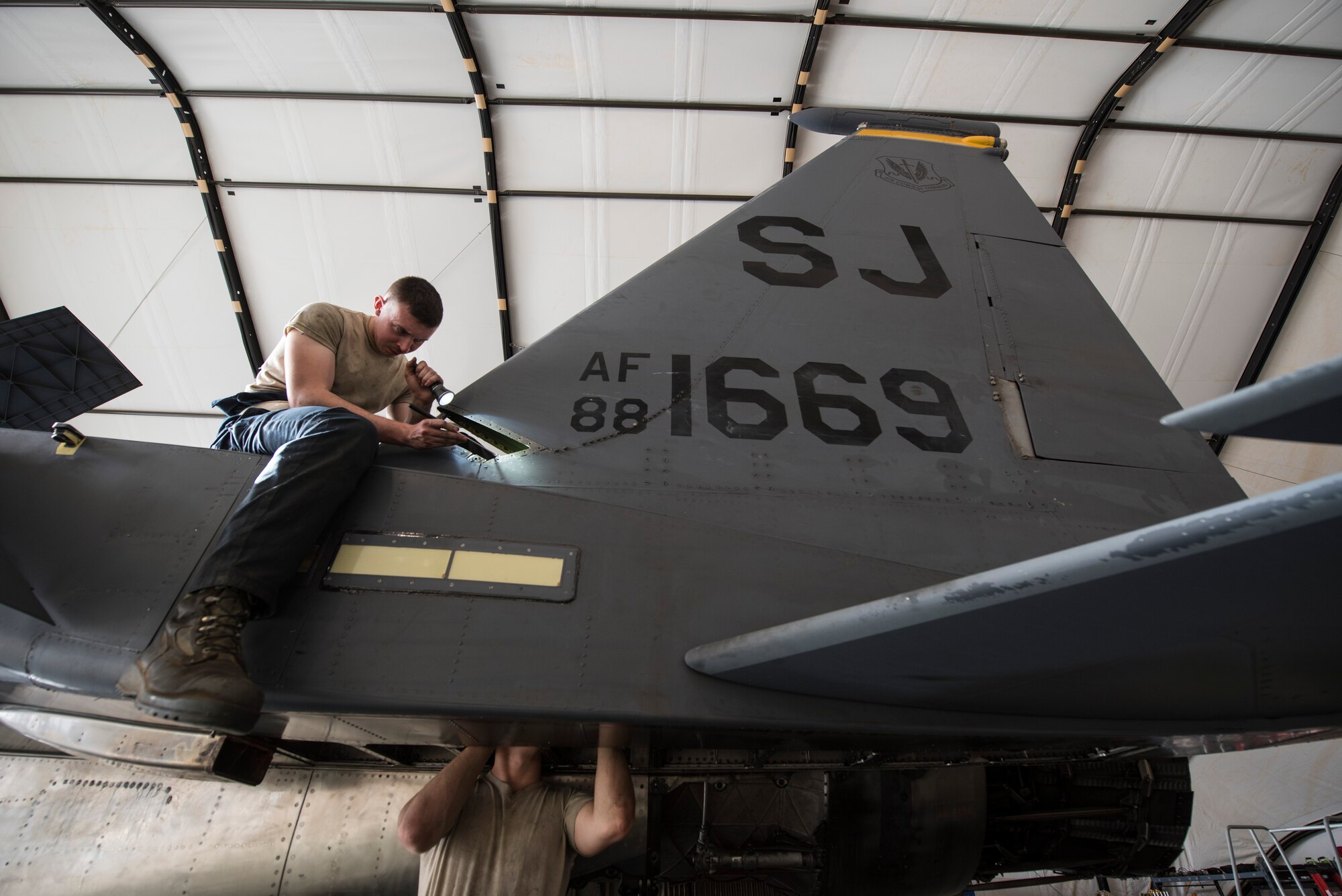 Maintainers assigned to the 332d Expeditionary Maintenance Squadron, inspect components on an F-15E Strike Eagle during phase maintenance March 1, 2018, at an undisclosed location. The 332 EMXS and their Strike Eagles are deployed from Seymour Johnson, Air Force Base, N.C., in support of Operation Inherent Resolve. (U.S. Air Force photo by Staff Sgt. Joshua Kleinholz)