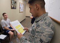 U.S. Air Force Airman 1st Class Melchor Philip, a traffic management Airman assigned to the 97th Logistics Readiness Squadron, reads instructions for the waist measurement portion of the physical fitness assessments, March 1, 2018, at Altus Air Force Base, Okla.