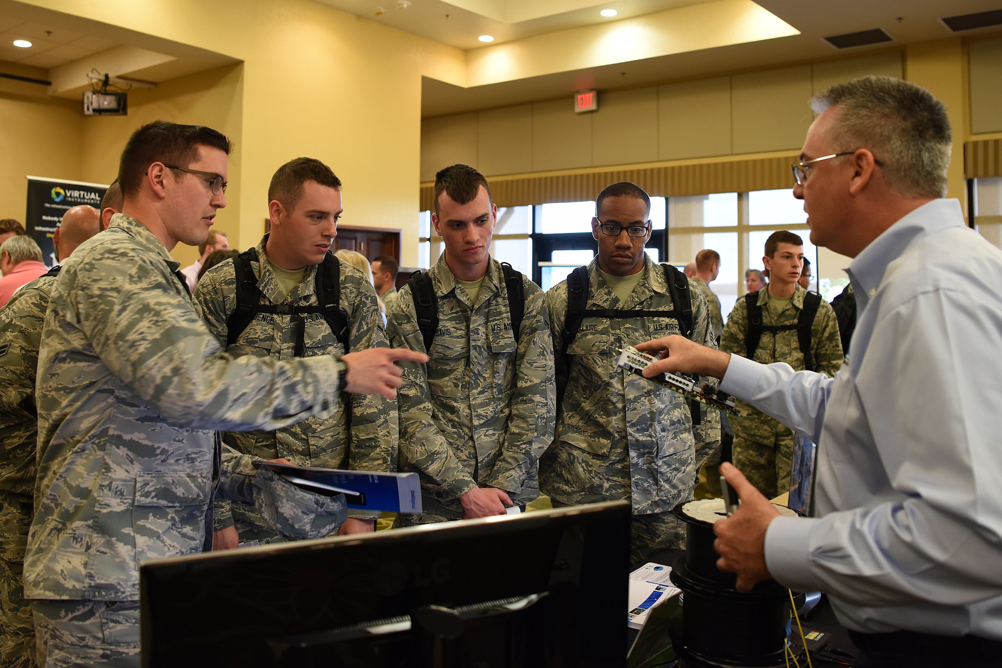 Don Menoher, Thinklogical director of sales, explains the capabilities of a client computer during the 2018 Keesler Technology Expo at the Bay Breeze Event Center Feb. 27, 2018, on Keesler Air Force Base, Mississippi. The expo was hosted by the 81st Communications Squadron and was free to all Defense Department, government and contractor personnel with base access. The event was held to introduce military members to the latest in technological advancements to bolster the Air Force’s capabilities in national defense. (U.S. Air Force photo by Airman 1st Class Suzanna Plotnikov)