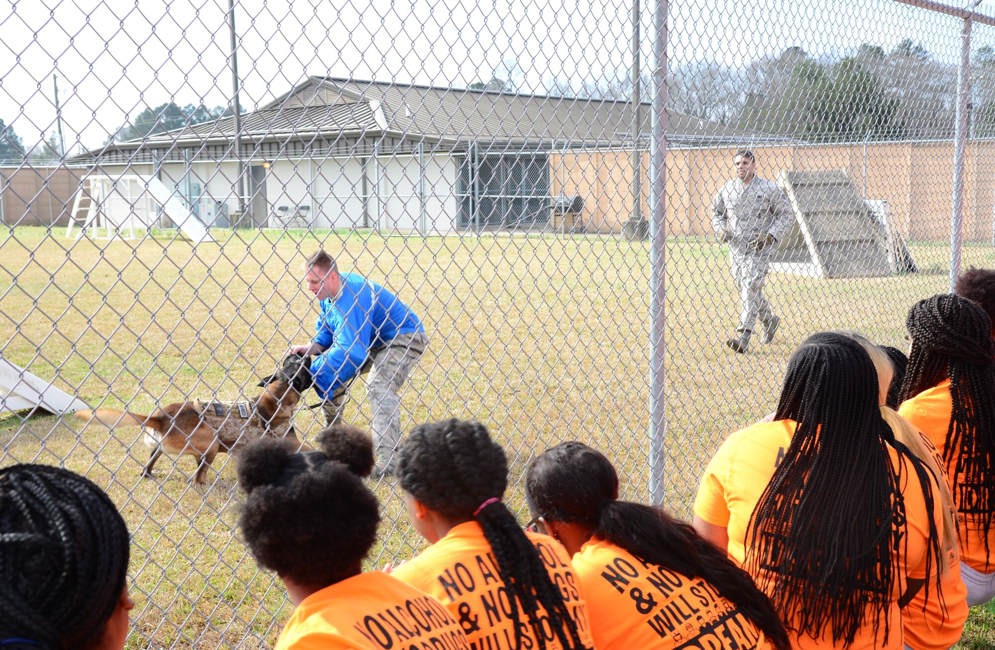 Staff Sgt. Jimmy Juarez Andrade, 14th Security Forces Squadron Military Working Dog handler, commands MWD Dito to attack Senior Airman Raymond Dwonznik, 14th SFS MWD handler, during a demonstration Feb. 23, 2018, on Columbus Air Force Base, Mississippi. Children from West Lowndes and Columbus High Schools started the day with a MWD demonstration before completing a Too Good for Drugs obstacle course. (U.S. Air Force photo by Airman 1st Class Beaux Hebert)