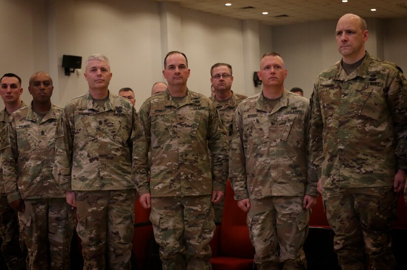 The command group for the Massachusetts National Guard’s 151st Regional Support Group and Kansas National Guard’s 635th Regional Support Group, and U.S. Army Central stand at attention during a change of authority ceremony February, 28.