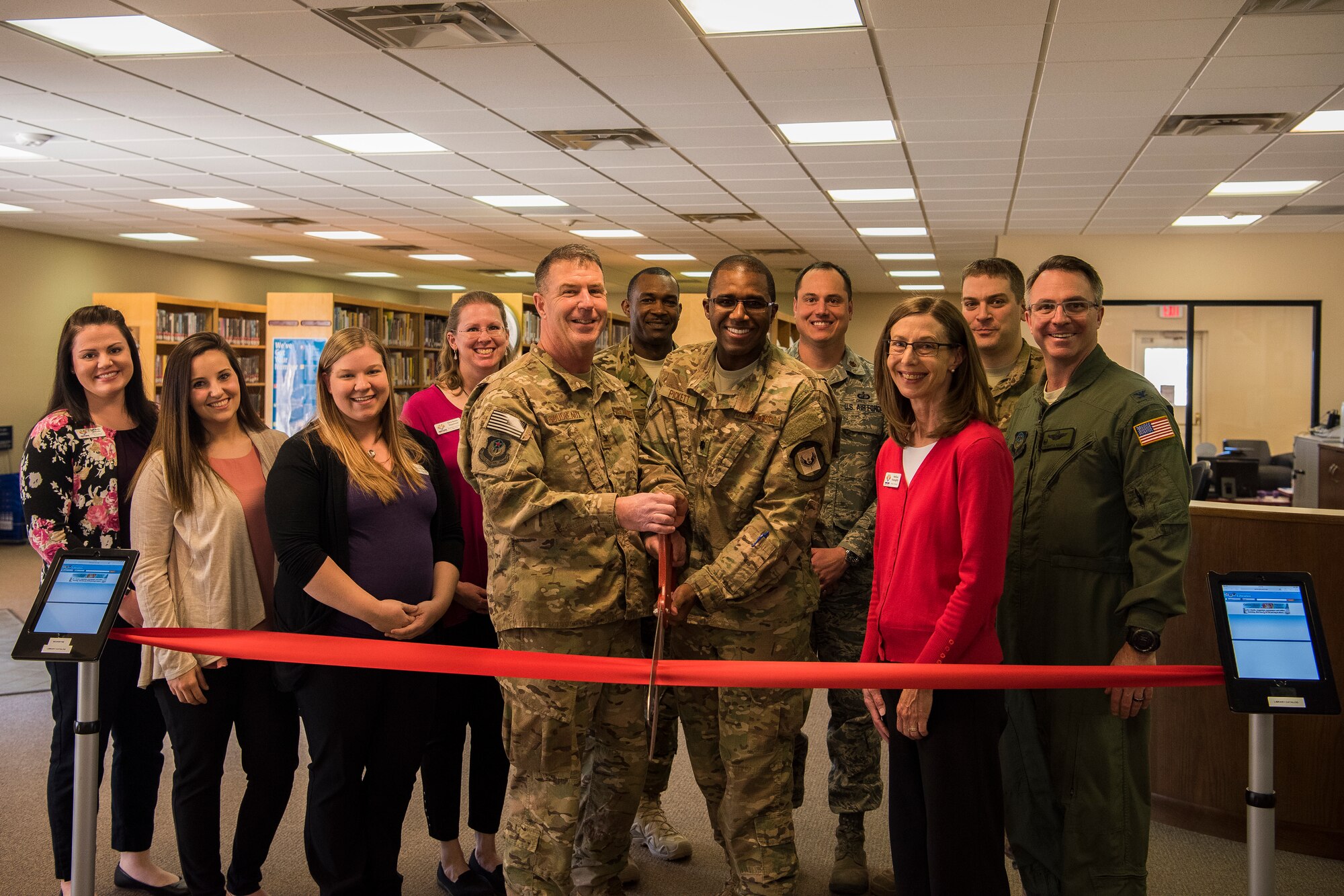 Wing leadership and community members perform a ribbon cutting ceremony for the re-opening of the Cannon Library on Cannon Air Force Base, N.M., March 1, 2018. The new additions to the library include an expanded children’s room, a multi-purpose room, a larger sitting area and quiet study rooms. (U.S. Air Force Photo by Airman 1st Class Vernon R. Walter III/Released)