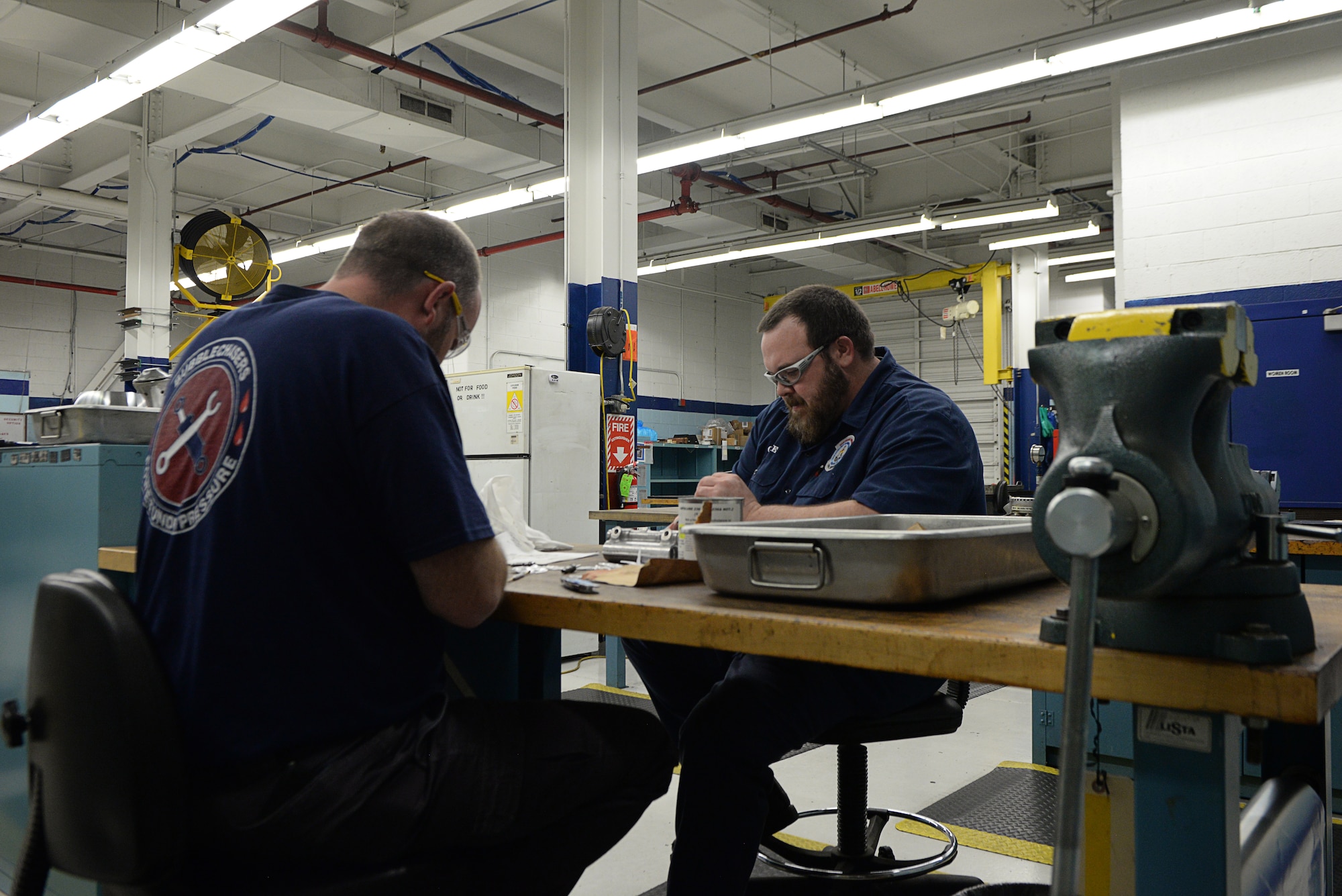 Terrell  “Obie” Hilley and Billy Cox, hydraulic technicians assigned to the 97th Maintenance Group, work on aircraft parts in the hydraulic shop February 27, 2018, Altus Air Force Base, Okla. The hydraulic shop recently reached 5,000 days with no injuries or lost time due to safety incidents. (U.S. Air Force photo by Airman Jeremy Wentworth/released)