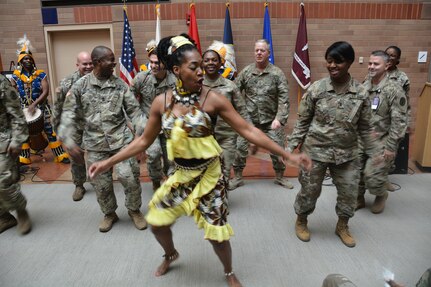 The Bramaya dance and drum troupe from Austin, Texas, entertains the audience with traditional West African music and dance at the Black History Month observance at Brooke Army Medical Center at Joint Base San Antonio-Fort Sam Houston Feb. 22. The dance troupe encouraged members of the audience to join them in the festivities.