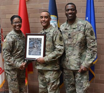 Army Col. Traci Crawford (left), Brooke Army Medical Center deputy commanding officer and Command Sgt. Maj. Deonn Cannon (right), BAMC Troop Command's command sergeant major, present Army Col. Derrick W. Flowers (center) with a token of appreciation during the BAMC Black History Month observance at Brooke Army Medical Center at Joint Base San Antonio-Fort Sam Houston Feb. 22. Flowers was the guest speaker for the event.