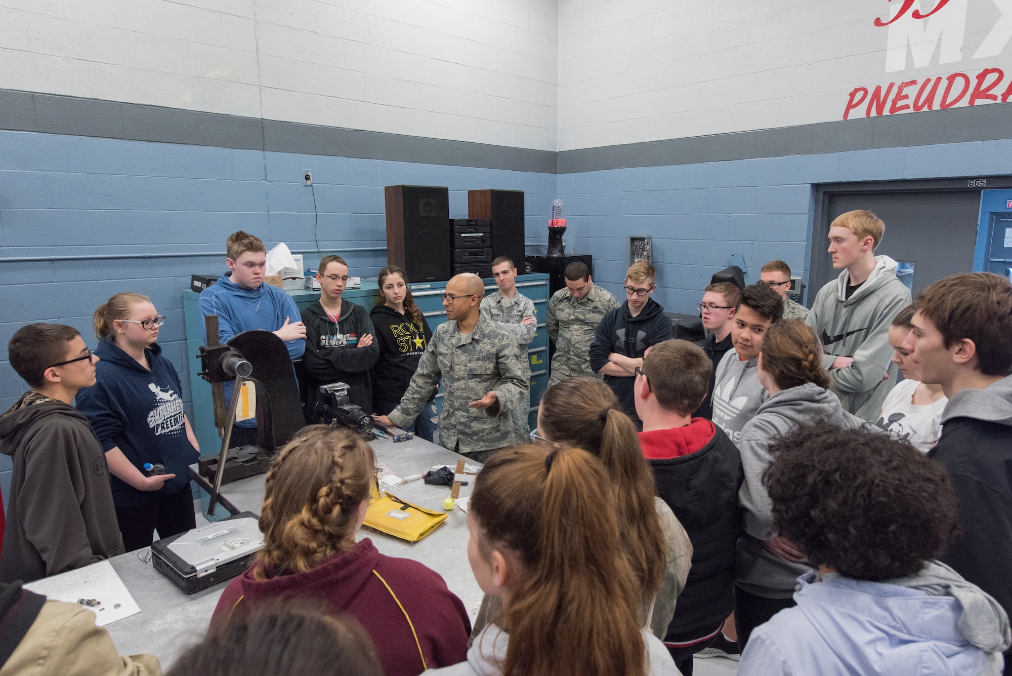 Senior Airman Angel Sanchez, 55th Maintenance Squadron Consolidated Support Flight aircraft hydraulics journeyman speaks to students from Bellevue East High School Feb. 27, 2018 at Offutt Air Force Base, Nebraska. The tour, which was the first of its kind, provided students a chance to see into the world of aircraft maintenance and reflect on real world applications of what they’ve learned in school. (U.S. Air Force photo by Senior Airman Jacob Skovo)