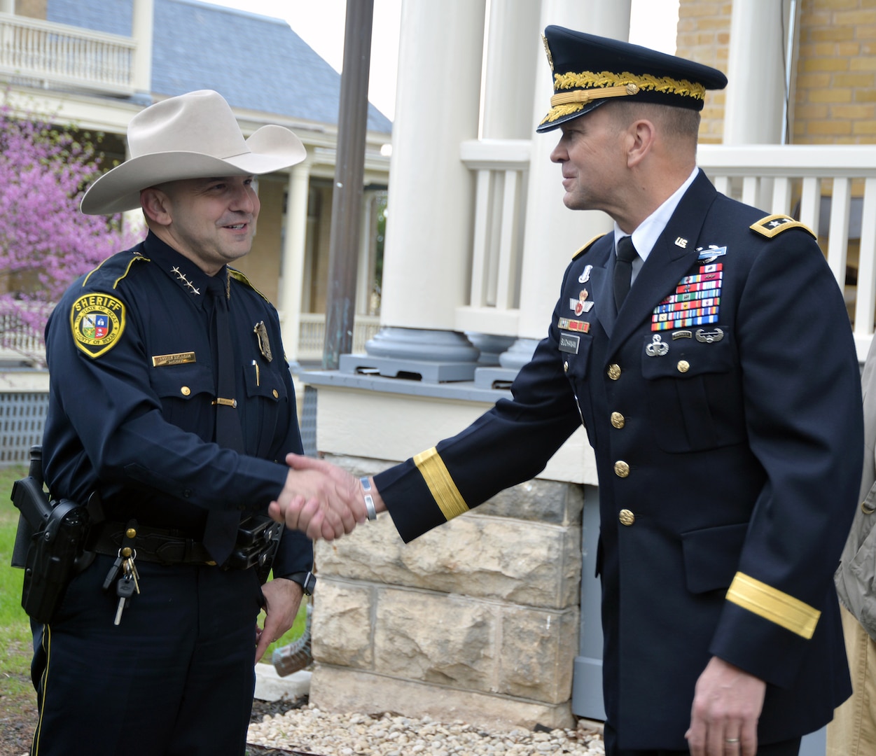 Lt. Gen. Jeffrey Buchanan (right), commanding general of U.S. Army North (Fifth Army), at Joint Base San Antonio-Fort Sam Houston, greets Bexar County Sheriff Javier Salazar (left) at the Foulois House after the ceremony celebrating the first military flight by Lt. Benjamin Foulois March 2.