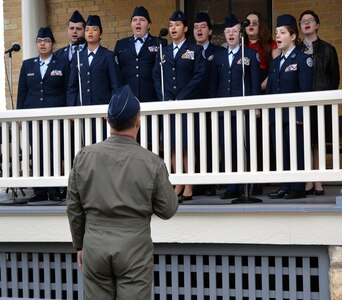 members of the Floresville High School Air Force Junior ROTC Chorale sings the national anthem during the 108th anniversary celebration of the first military flight made by Army Lt. Benjamin Foulois at Joint Base San Antonio-Fort Sam Houston on March 2, 1910.