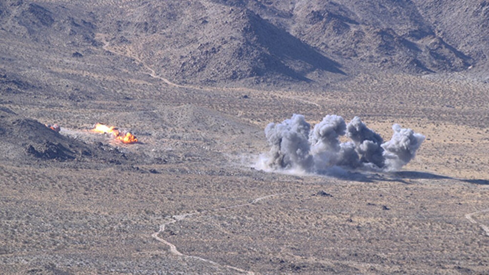 Live-bombs delivered by aircraft from the guidance of 93d Air Ground Operations Wing Joint Terminal Attack Controllers, explode on a simulated battlefield during a rotation at Ft. Irwin, California’s, National Training Center, Feb. 22, 2018. During the month-long rotation, 93d Air Ground Operations Wing units embedded with approximately 4,000 soldiers in the largest force-on-force live-fire exercise in the world. The 93d AGOW provided tactical air control party support to enhance interoperability for major combat operations downrange. (U.S. Air Force photo by Senior Airman Greg Nash)