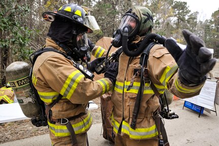 Airmen decontaminate their personal protective equipment during mobility exercise Bold Eagle Feb. 28, 2018, at Joint Base Charleston, S.C.