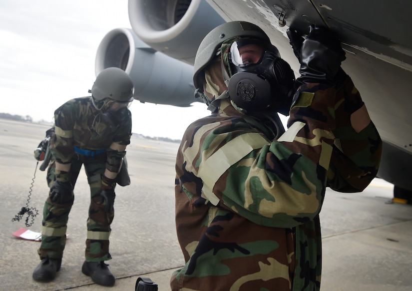 Airman 1st Class Jonathon Davis, right, 437th Aircraft Maintenance Squadron, and Airman 1st Class Jordan Smith, left, 437th Maintenance Squadron, inspect a C-17 Globemaster III in a simulated chemical, biological, radiological and nuclear environment as part of Mobility Exercise Bold Eagle Feb. 28, at Joint Base Charleston, S.C.
