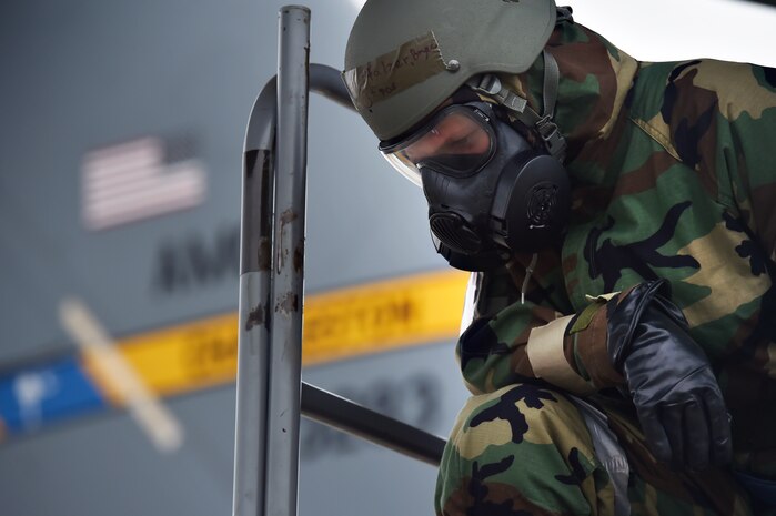 Airman 1st Class Bryce Pfalzer, 437th Aircraft Maintenance Squadron, inspects a wing of a C-17 Globemaster III in a simulated chemical, biological, radiological and nuclear environment as part of Mobility Exercise Bold Eagle Feb. 28, at Joint Base Charleston, S.C.