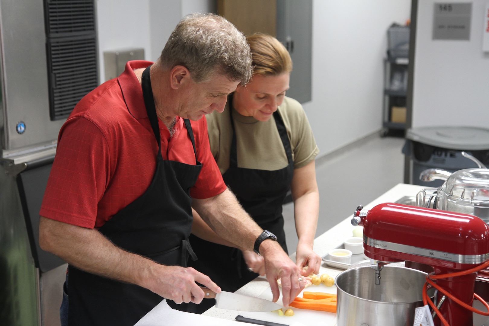 Lt. Col. Christine Edwards (right), an Army dietician, prepares food alongside of her husband, David Abraham, during a marriage enrichment class at the Vogel Resiliency’s teaching kitchen Feb. 23  at Joint Base San Antonio-Fort Sam Houston.
