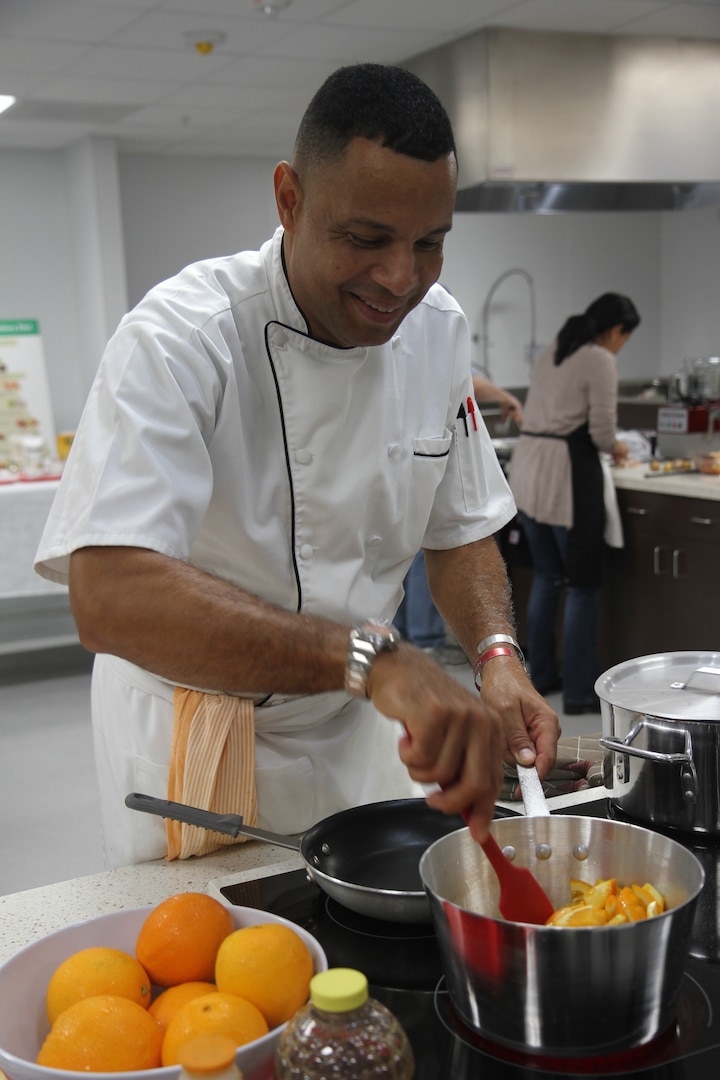 Sgt. 1st Class Raphael Bonair, a culinary specialist with U.S. Army North (Fifth Army) and the enlisted aide to Lt. Gen. Jeffery S. Buchanan, the senior commander for ARNORTH, shows the couples in attendance how to make an orange glaze during a marriage enrichment class at the Vogel Resiliency’s teaching kitchen Feb. 23 at Joint Base San Antonio-Fort Sam Houston.