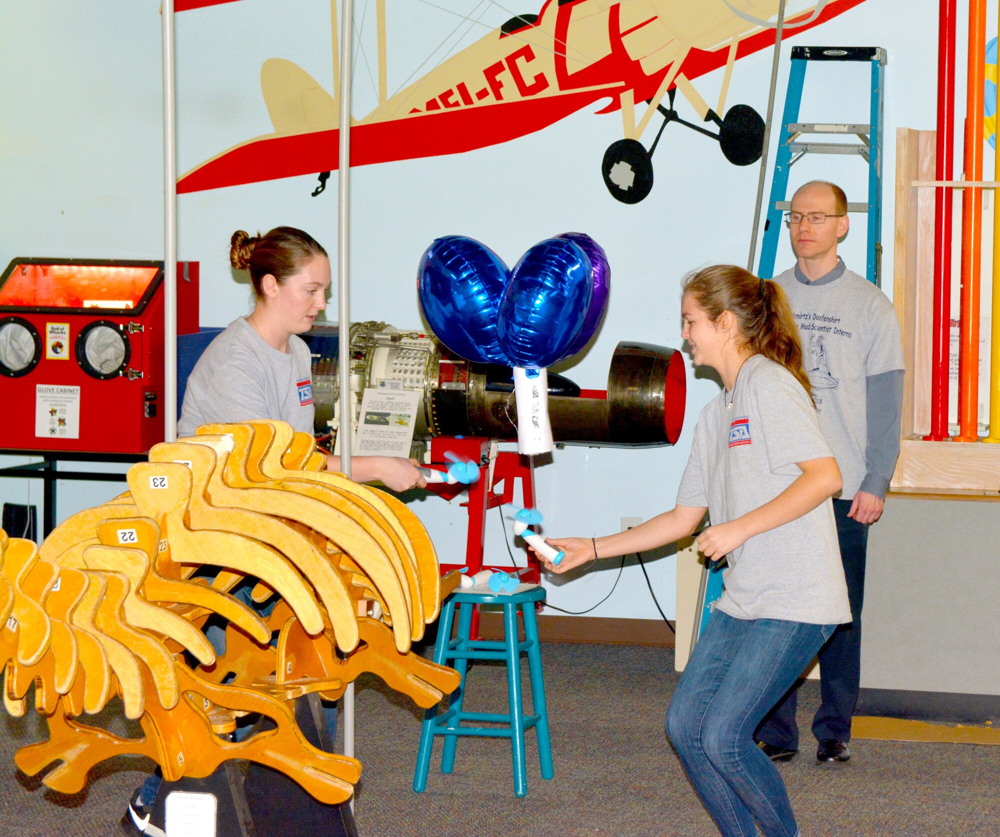 Volunteer engineers organized events in recognition of National Engineers Week, Feb. 18-24, to help students prepare for future careers in engineering. During the Arnold Air Force Base Engineers Week Student Design Competition Feb. 20 at the Hands-On Science Center, Tullahoma, Alina Parks and Leanne Turpin from Franklin County High School, maneuver a Blimpinator around obstacles to a predetermined destination while SDC referee Dr. Taylor Swanson observes. The team was able to maneuver with the best time and skill and won first place in the competition. Twenty-one, two-student teams were challenged to construct a vehicle, from provided scraps and materials, which would travel through the air while also moving around obstacles. Seven schools from four counties participated in the competition. (Courtesy photo)