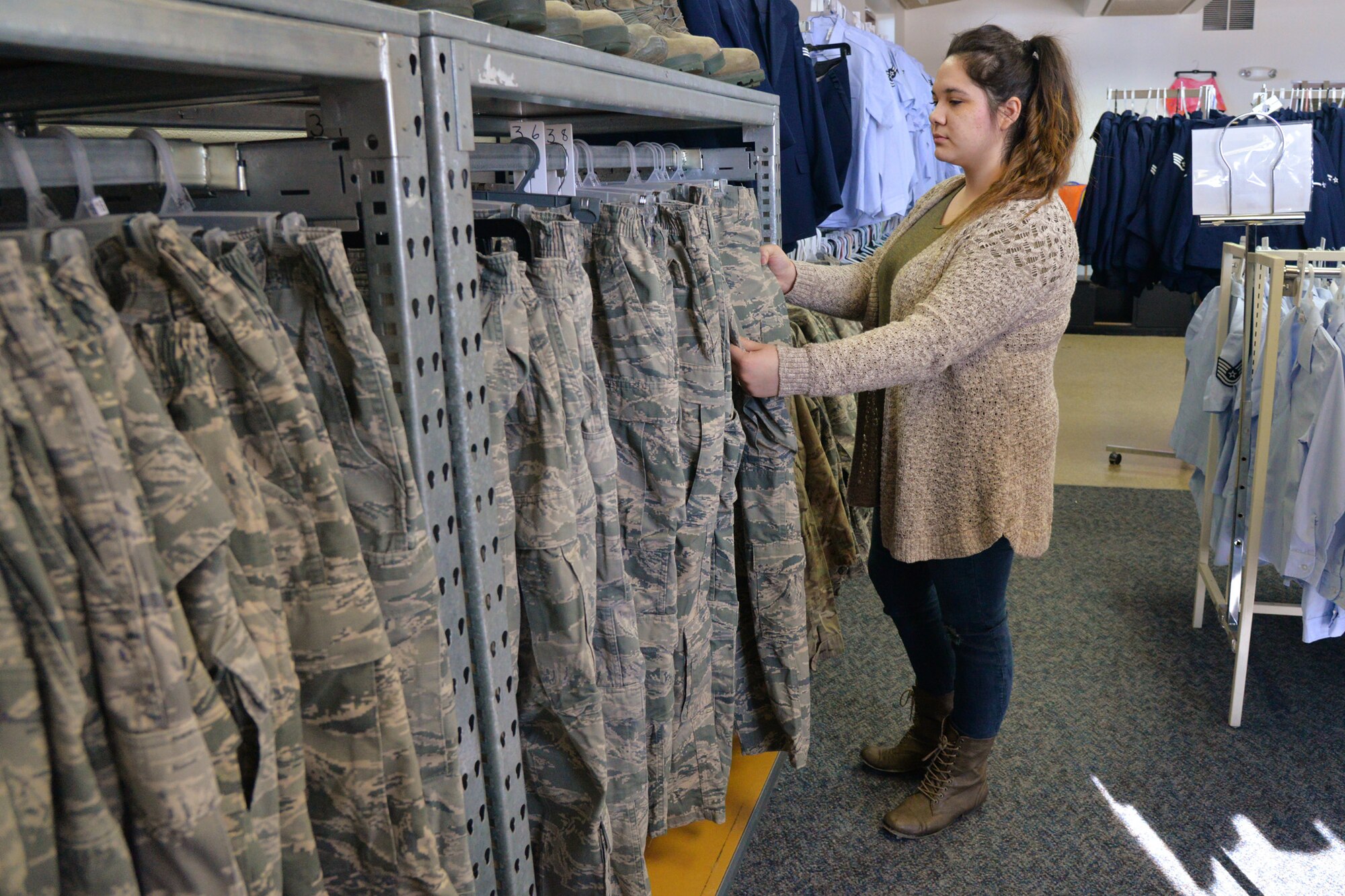 Joslin Knightstep, Airman’s Attic volunteer coordinator,
 looks through military clothing Feb. 26, 2018, at Malmstrom Air Force Base, Mont.