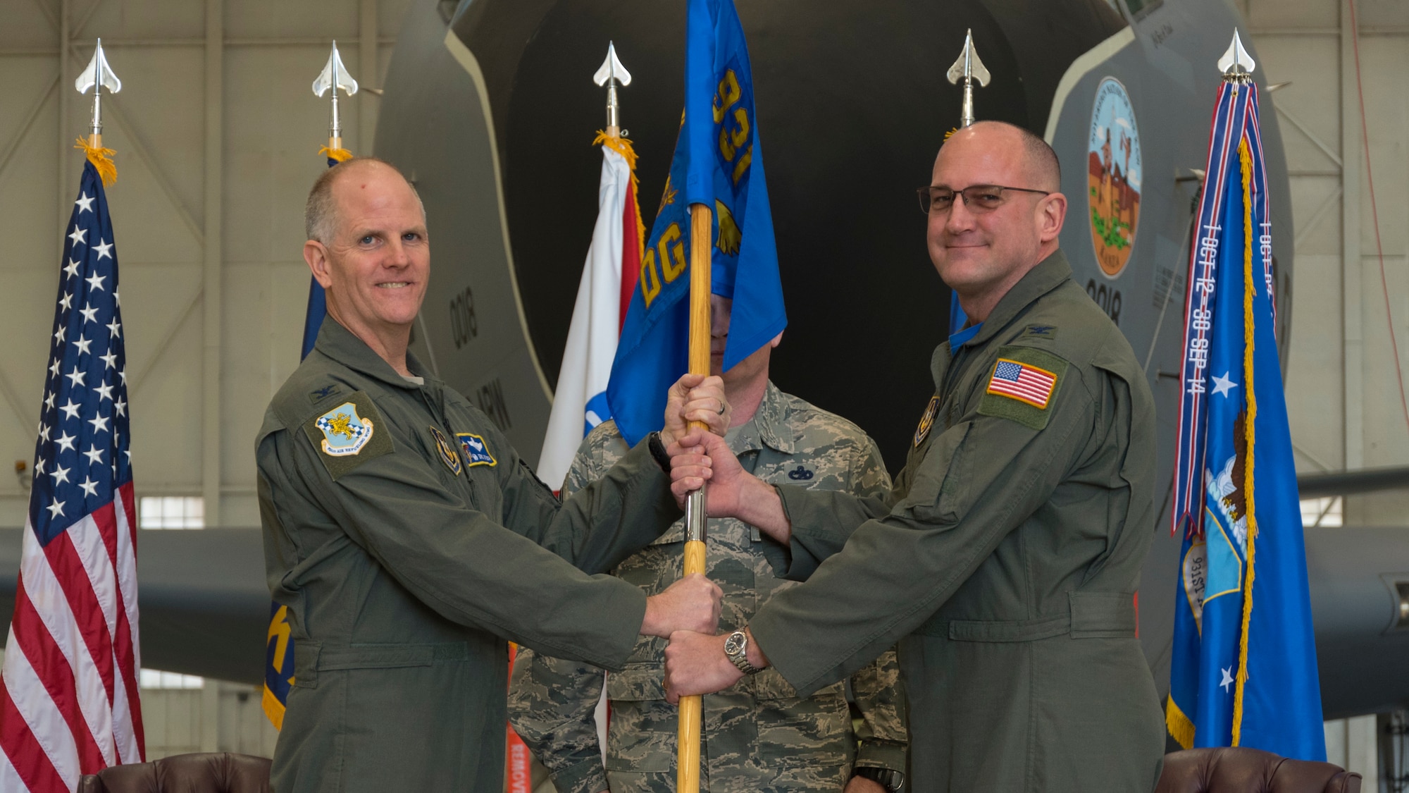 Col. Kevin Rainey, right, 931st Operations Group commander, receives the 931 OG guidon from Col. Eric A. Vitosh, 931st Air Refueling Wing Commander, during an assumption of command ceremony, Mar. 2, 2018, at McConnell Air Force Base, Kan.