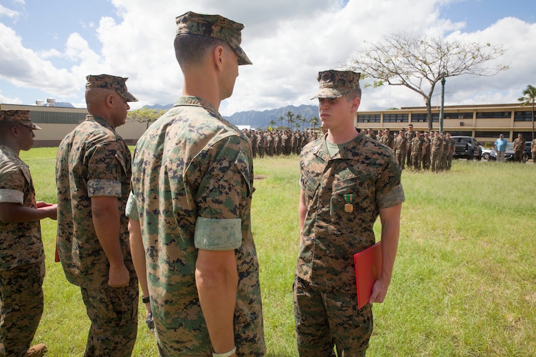 Sgt. Jeffrey Igleheart, a signals intelligence analyst with 3rd Radio Battalion, is awarded the Navy and Marine Corps Achievement Medal, Marine Corps Base Hawaii, Feb. 16, 2018. Three Marines, including Igleheart, conducted a late night search and rescue for a lost hiker back in January 2018. The Marines covered 10 miles at about 3000 feet in elevation under rainy conditions, eventually finding and returning back with the hiker. (U.S. Marine Corps photo by Sgt. Jesus Sepulveda Torres)