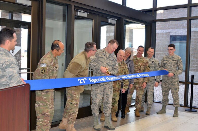 Col. Christopher Patrick, Commander, 27th Special Operations Medical Group, prepares to cut the ribbon officially opening the new medical/dental clinic, Feb. 23, 2018.