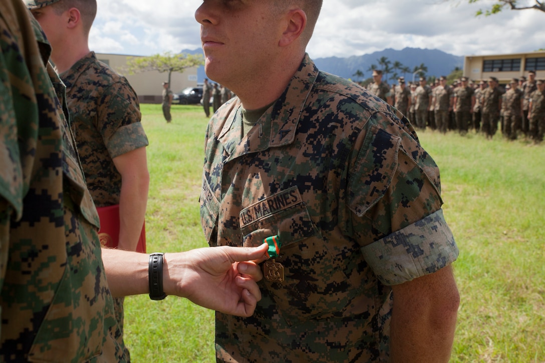 Lance Cpl. Jacob Baker, a cryptologic linguist with 3rd Radio Battalion (3rd RADBN), is awarded the Navy and Marine Corps Achievement Medal by Lt. Col. William Osborne, the commanding officer of 3rd RADBN, Marine Corps Base Hawaii, Feb. 16, 2018. Three Marines, including Baker, conducted a late night search and rescue for a lost hiker back in January 2018. The Marines covered 10 miles at about 3000 feet in elevation under rainy conditions, eventually finding and returning back with the hiker. (U.S. Marine Corps photo by Sgt. Jesus Sepulveda Torres)