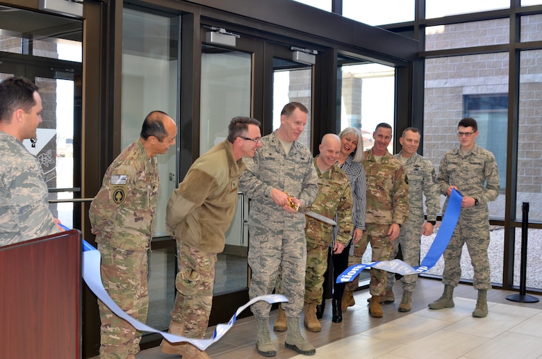 Col. Christopher Patrick, Commander, 27th Special Operations Medical Group, cuts the ribbon officially opening the new medical/dental clinic, Feb. 23, 2018.