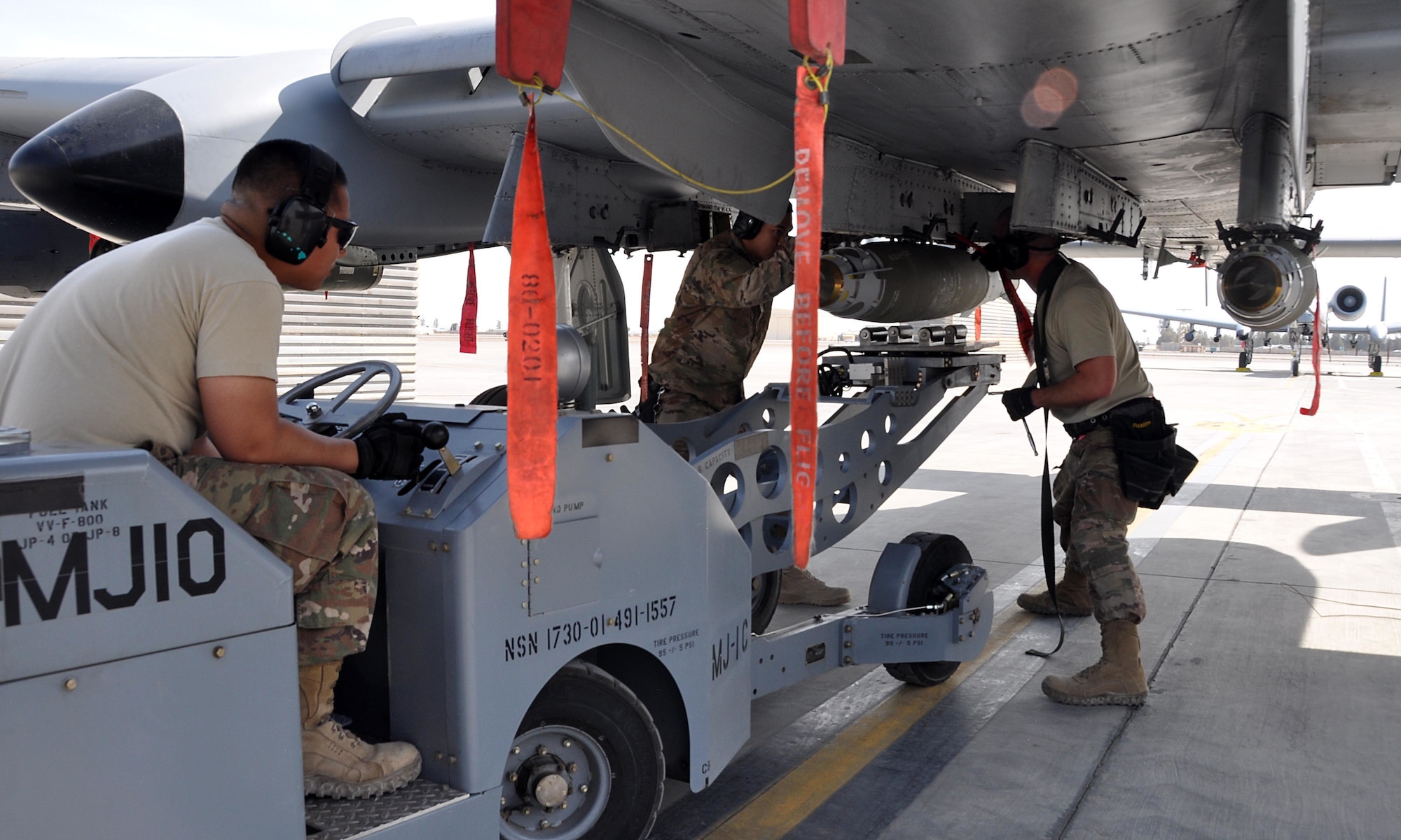 Tech. Sgt. Nathan Wesley, and Airmen 1st Class Rey Nino Estrella and Carlito Yalon, weapons loader Airmen assigned to the 303rd Expeditionary Fighter Squadron, load a 500 pound GPS-guided bomb on an A-10 Thunderbolt II before a mission at Kandahar Airfield, Afghanistan Feb. 10, 2018.