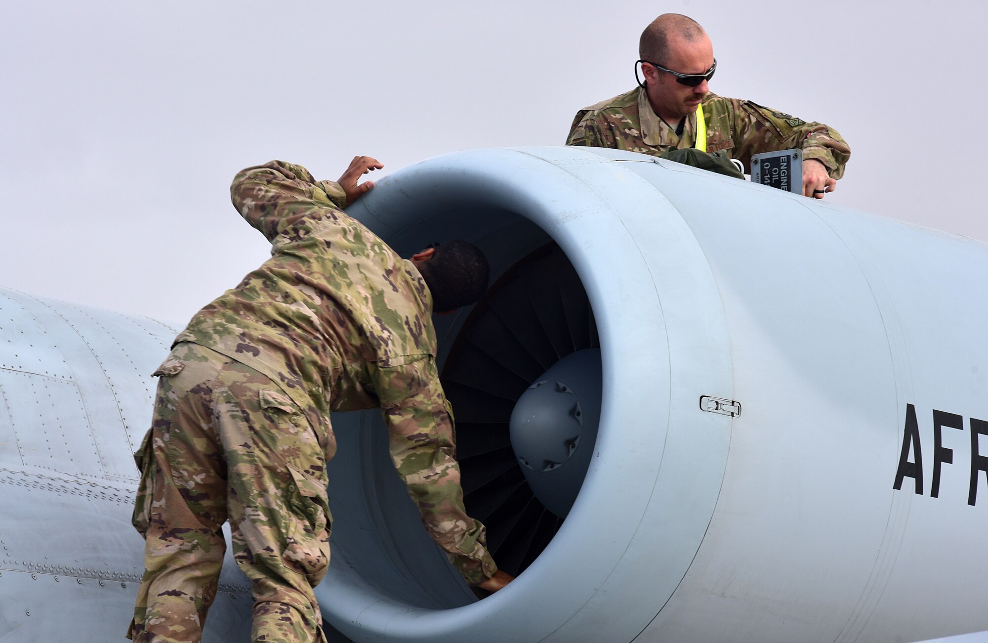 Staff Sgt. Todd Regas and Tech. Sgt. Joeseph Embrey, maintenance Airmen assigned to the 303rd Expeditionary Fighter Squadron, inspect an engine on the A-10 Thunderbolt II after a flight at Kandahar Airfield, Afghanistan, Feb. 27, 2018.